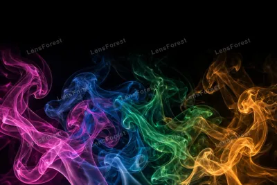 Vivid magenta, blue, green and gold colored smoke swirls on a black background
