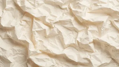 Full-frame crumpled cream paper texture with soft shadows in the folds, a warm vintage background for designs